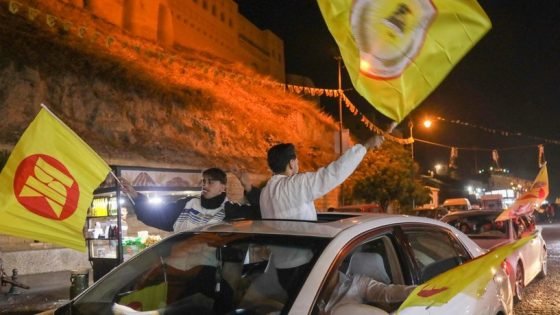 Supporters of the Kurdistan Democratic Party (KDP) celebrate their party's victory in the parliamentary election in a street in Arbil, the capital of Iraq's autonomous northern Kurdish region, on October 21, 2024. (Photo by Safin HAMID / AFP)